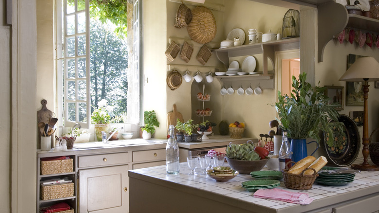Kitchen with several baskets hung on the wall. on an island, and used for shelf storage.
