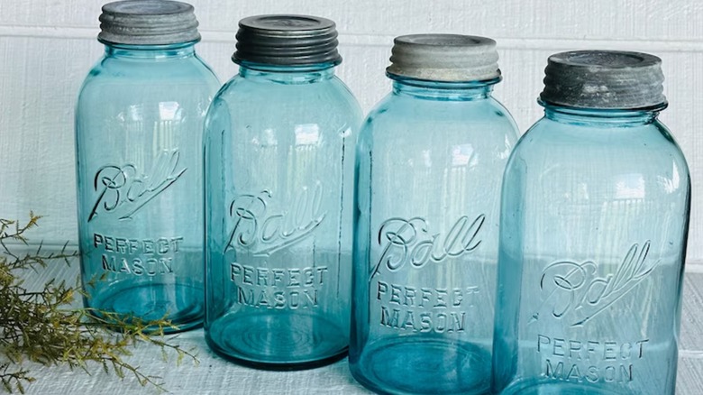 4 blue Ball mason jars with metal lids.