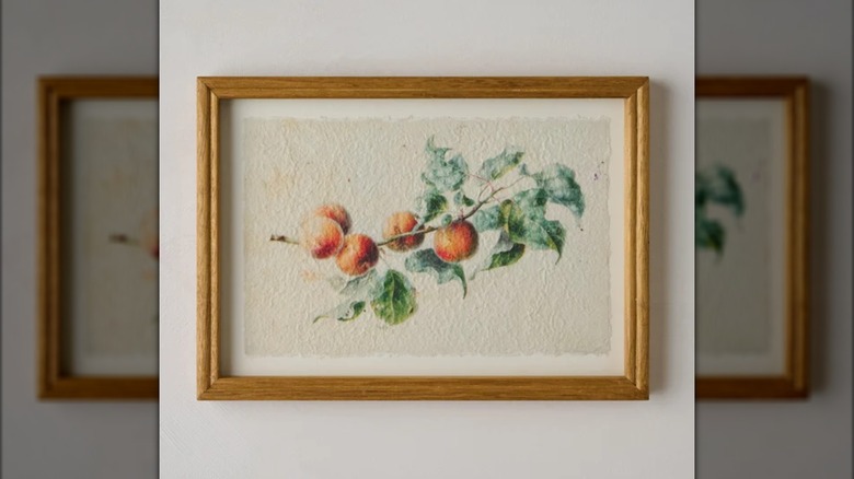 Peaches on branches wall art in frame.