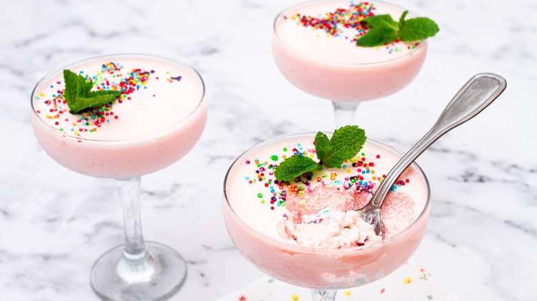 Three portions of fruit-flavored mousse on a marble table