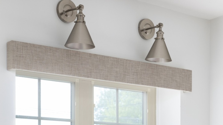 Lighting fixtures are displayed above a kitchen window