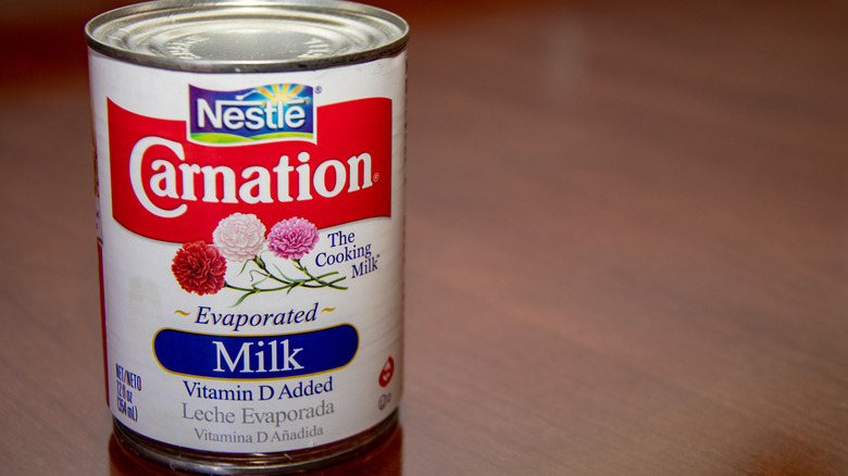 A can of Nestle Carnation evaporated milk on a wooden table
