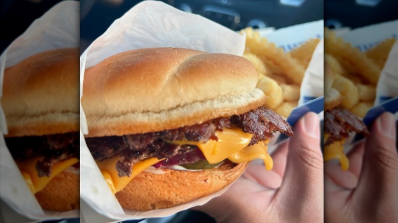 A person holding a ButterBurger cheese from Culver's