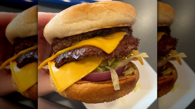 A person holding The Culver's Deluxe ButterBurger