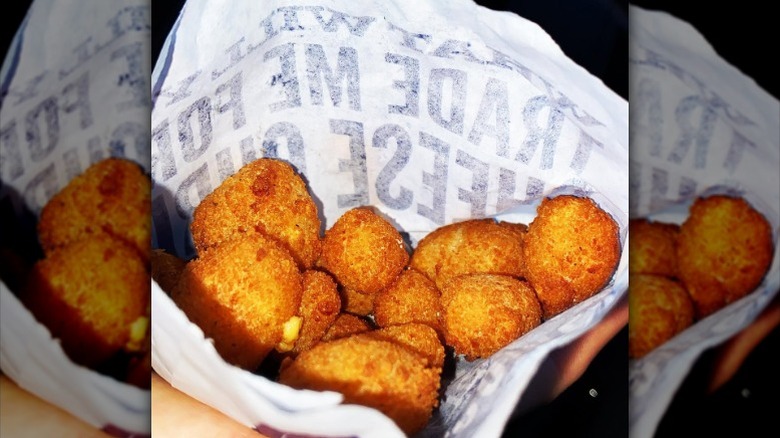Wisconsin cheese curds from Culver's in a white paper bag