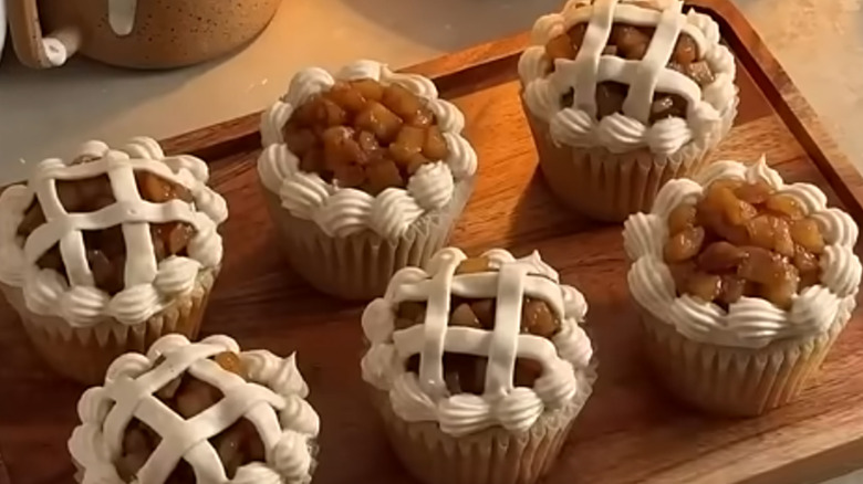 six apple pie cupcakes that look like real apple pies on a cutting board