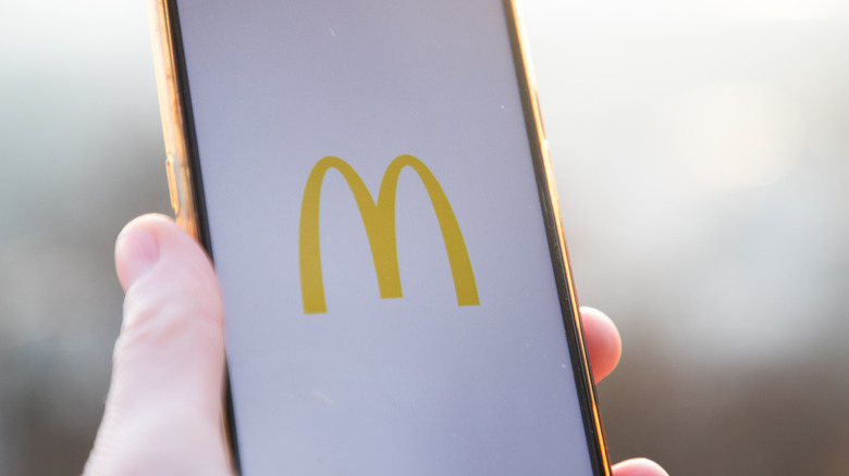The McDonald's logo is displayed on a cell phone