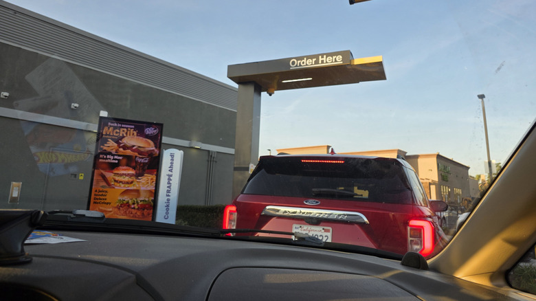 Cars sit in a queue at a McDonald's drive-thru
