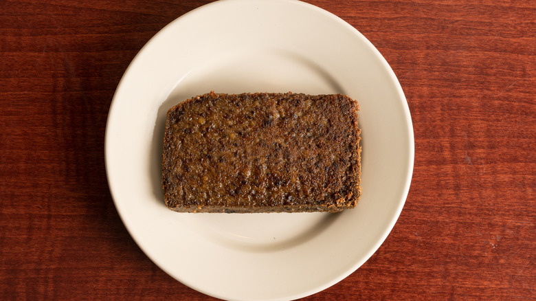 A fried piece of scrapple on a white plate