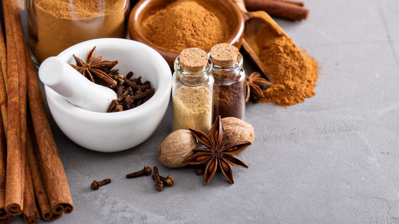 A bunch of spices in bowls and placed on a table