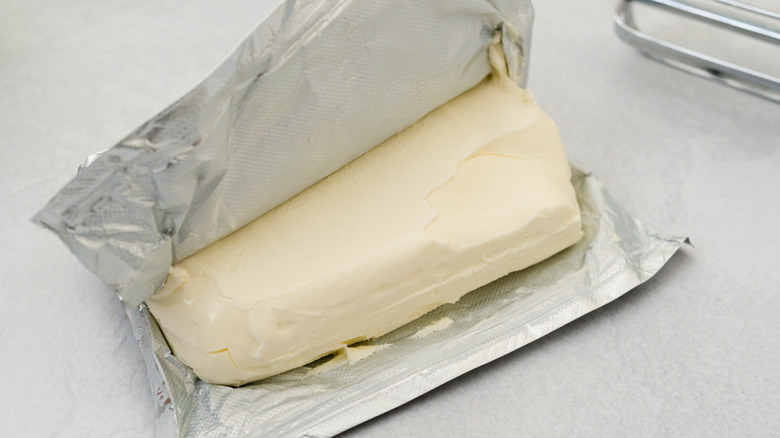 A block of cream cheese on a white table
