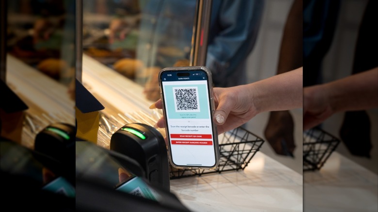 A customer scans the Golden Corral rewards app at the counter