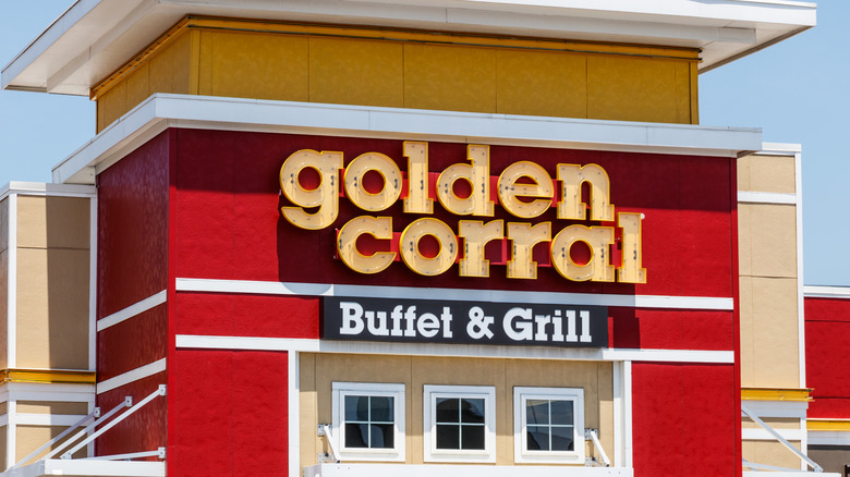 A Golden Corral sign on a red and beige building