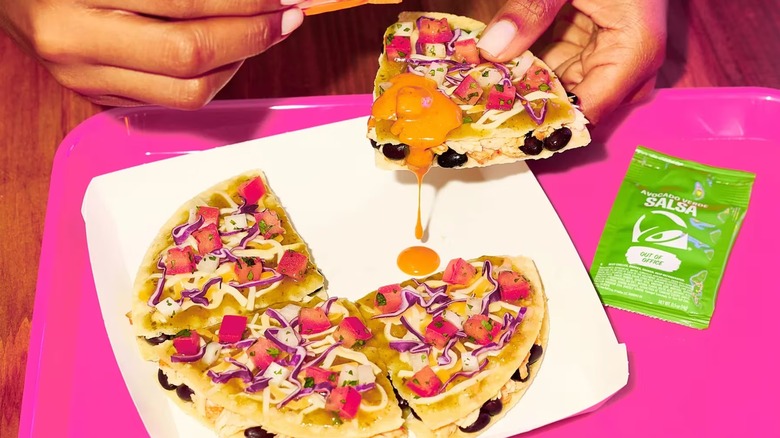 A Cantina Chicken Mexican Pizza being eaten at Taco Bell
