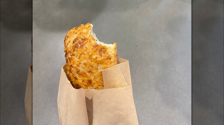 A Costco food court chicken bake, with a bite taken out of it