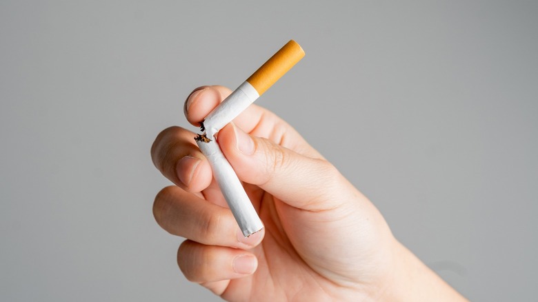 Breaking cigarette in half