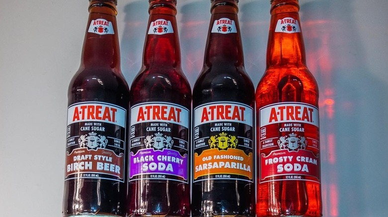 A line of glass A-Treat soda bottles of different flavors