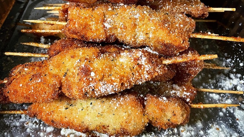 Close-up on skewers of city chicken on a tray