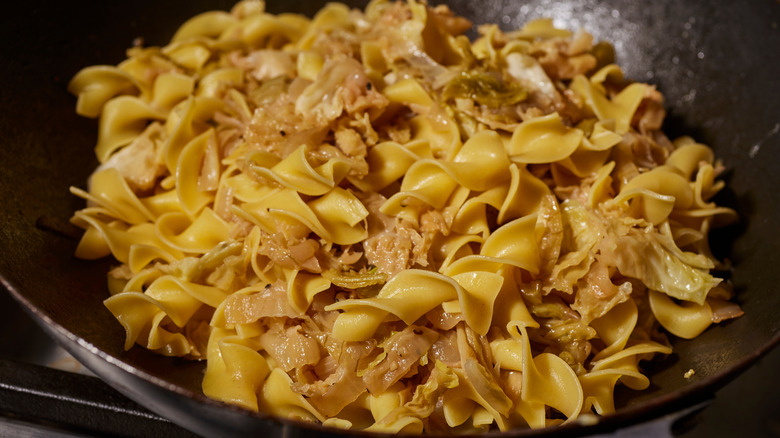 Close-up on a skillet of haluski noodles and cabbage