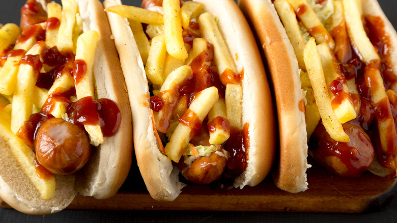Overhead view of three Polish Boy sandwiches on wood board