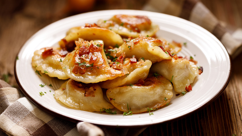 Close-up on a plate full of perogies set on a table