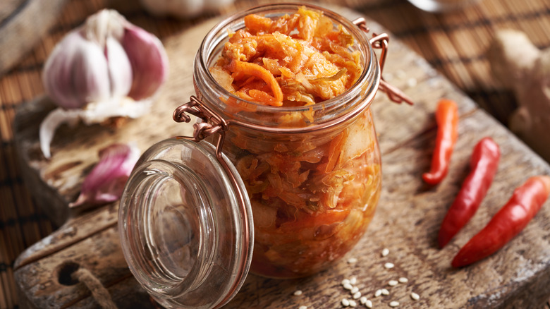 Kimchi in a glass jar placed on a wooden table