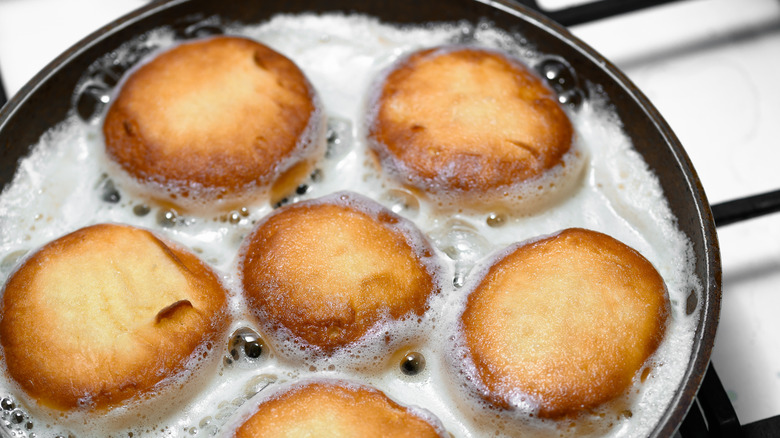Doughnuts being fried in rancid cooking oil