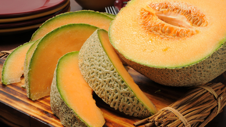 Sliced cantaloupe melon on a wooden board