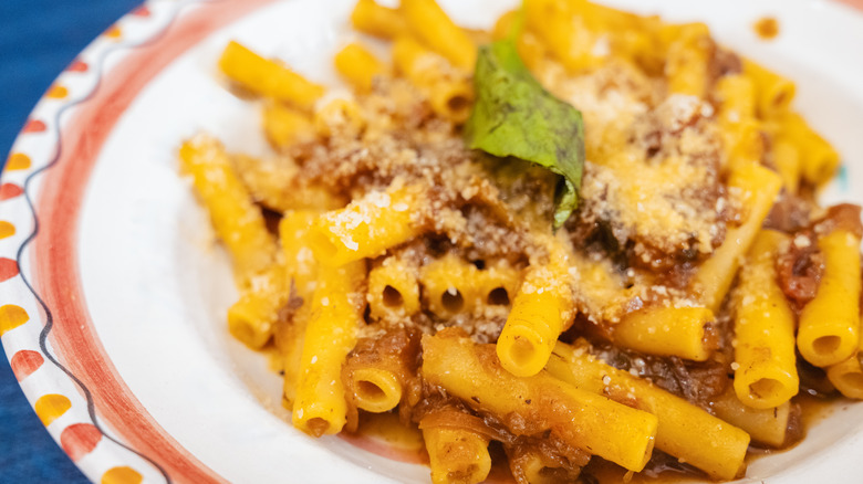 Pasta with sauce and Parmesan cheese, on a plate