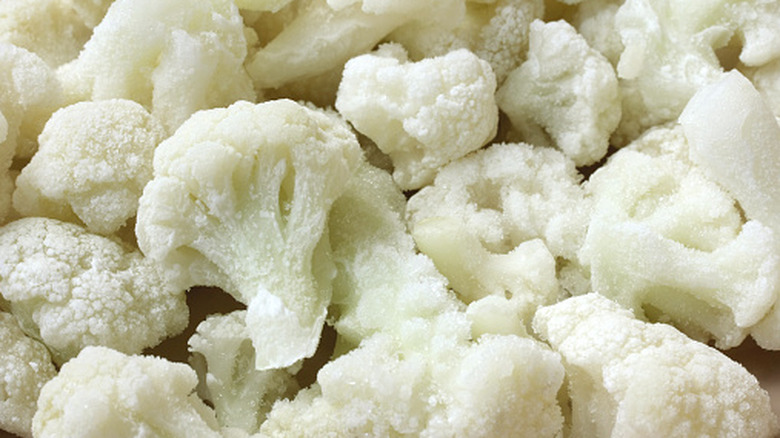 Closeup of many frozen cauliflower florets.