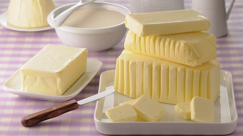 Stacks of butter on gingham tablecloth 