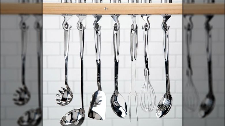 All-Clad stainless steel utensils hanging from hooks