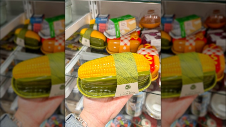 Hand holding corn-shaped butter dish in HomeGoods