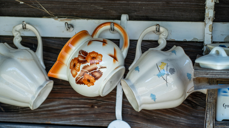 Vintage painted pottery hanging from hooks