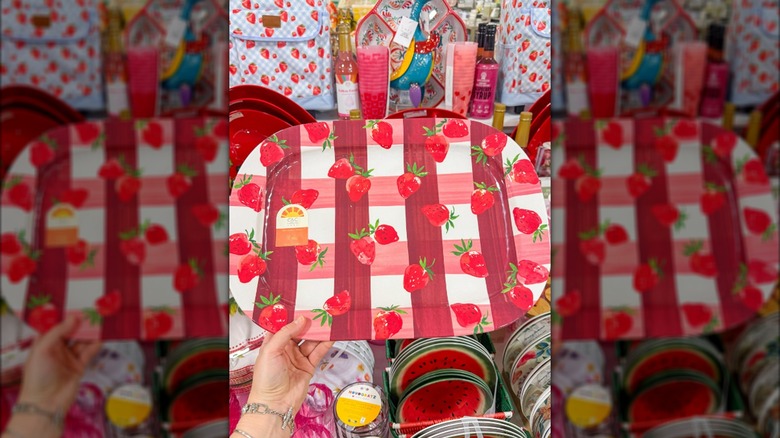 Hand holding tray with strawberry pattern