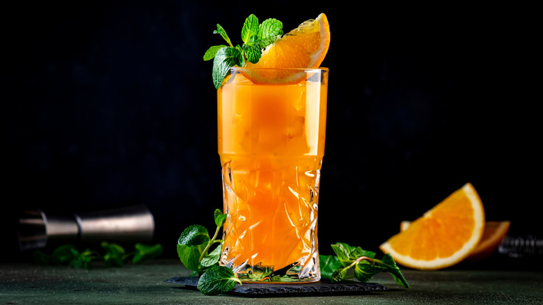 Orange cocktail against a black background