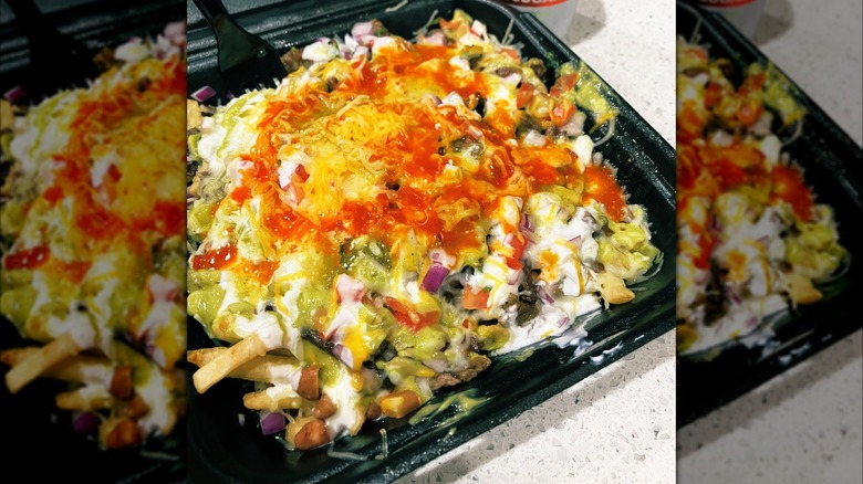 Carne asada fries in a takeout tray