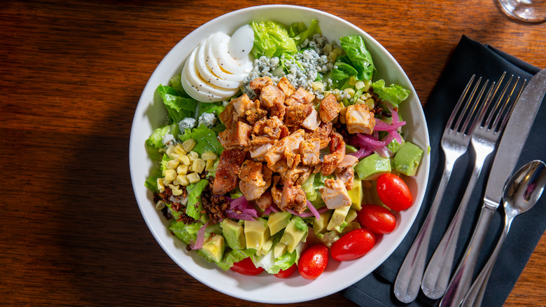 Top-down view of a Cobb salad in a bowl