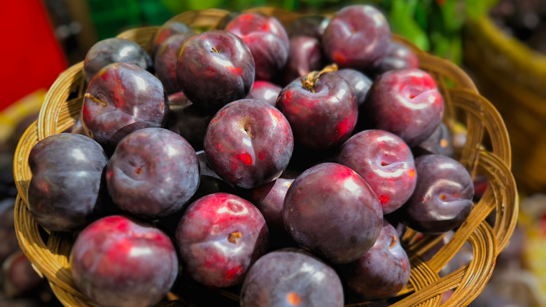 A basket full of fresh plums