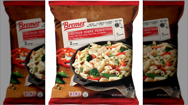 A plastic bag of frozen Bremer Chicken Penne Primavera on a white background