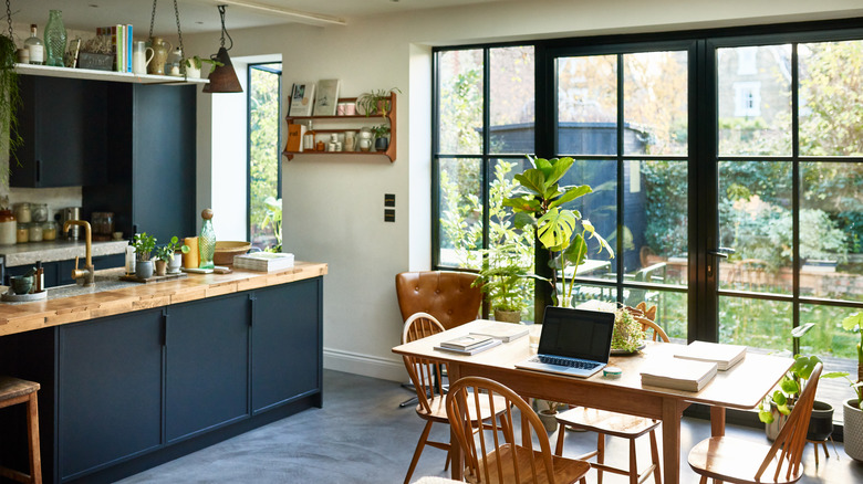 A modern kitchen with large, nearly floor to ceiling windows