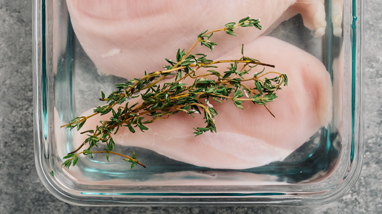 brined chicken in glass dish