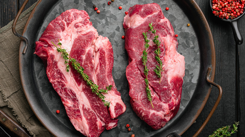 Overhead view of two raw steaks