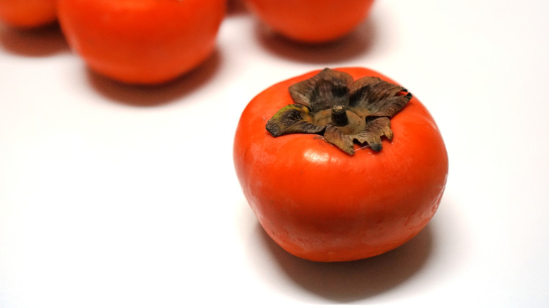Persimmons on white background