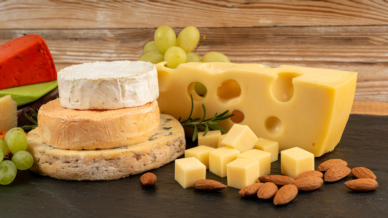 A board of cheeses and almonds and grapes