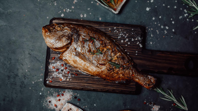 Grilled fish with salt, herbs, and spices