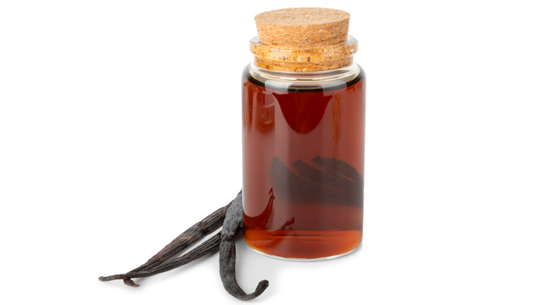 A bottle of vanilla extract with vanilla beans