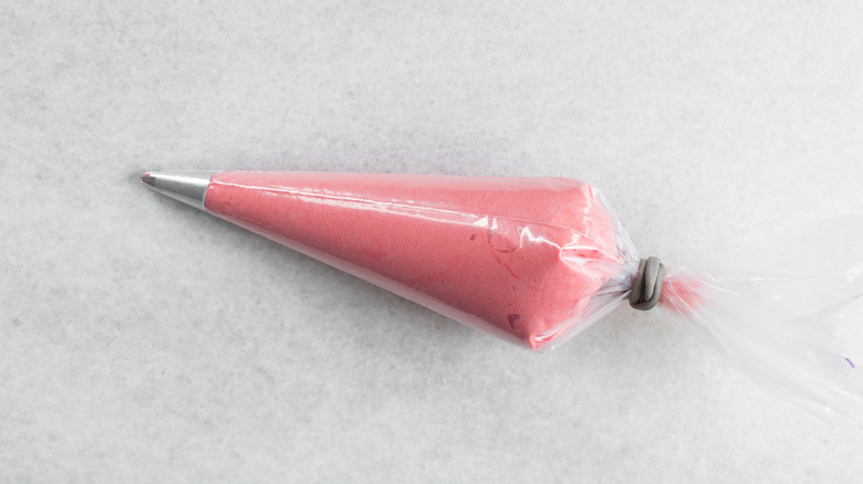 Pink buttercream in a piping bag