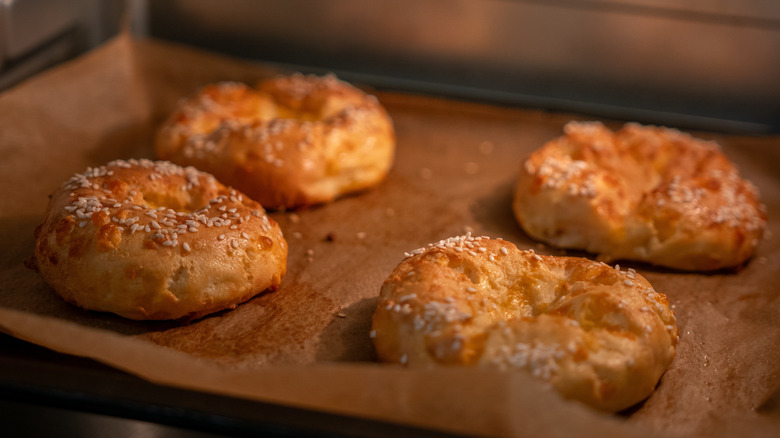 Pastries bake on parchment paper in an oven