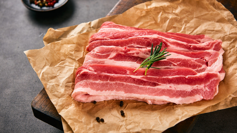 Raw pork belly on parchment paper